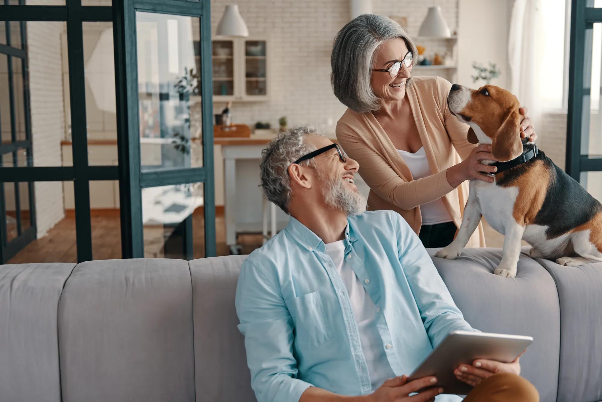 Couple and dog in new home living area