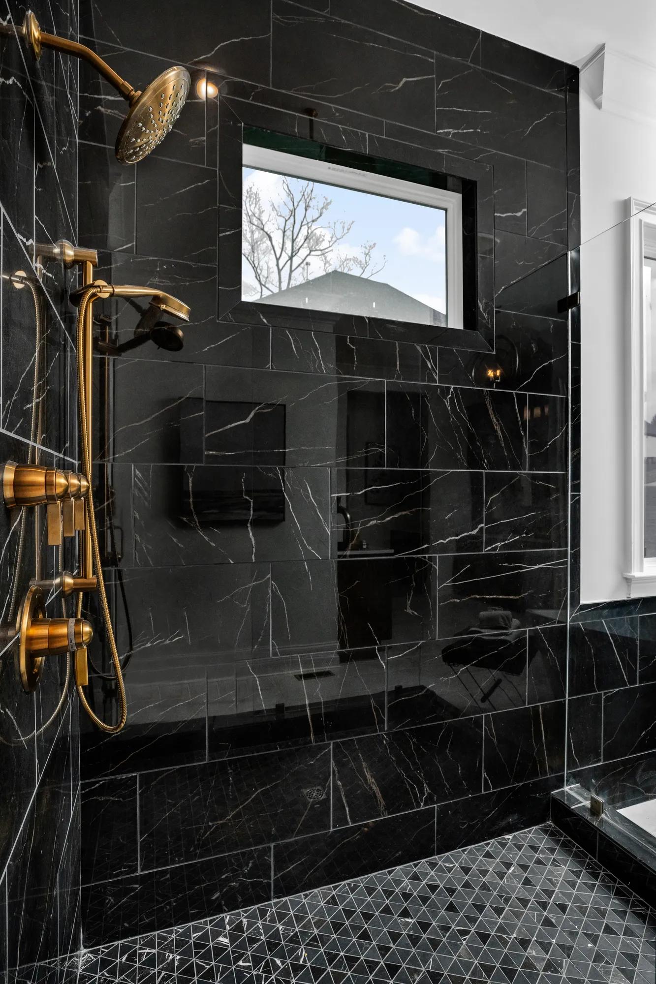 custom shower with gold fixtures