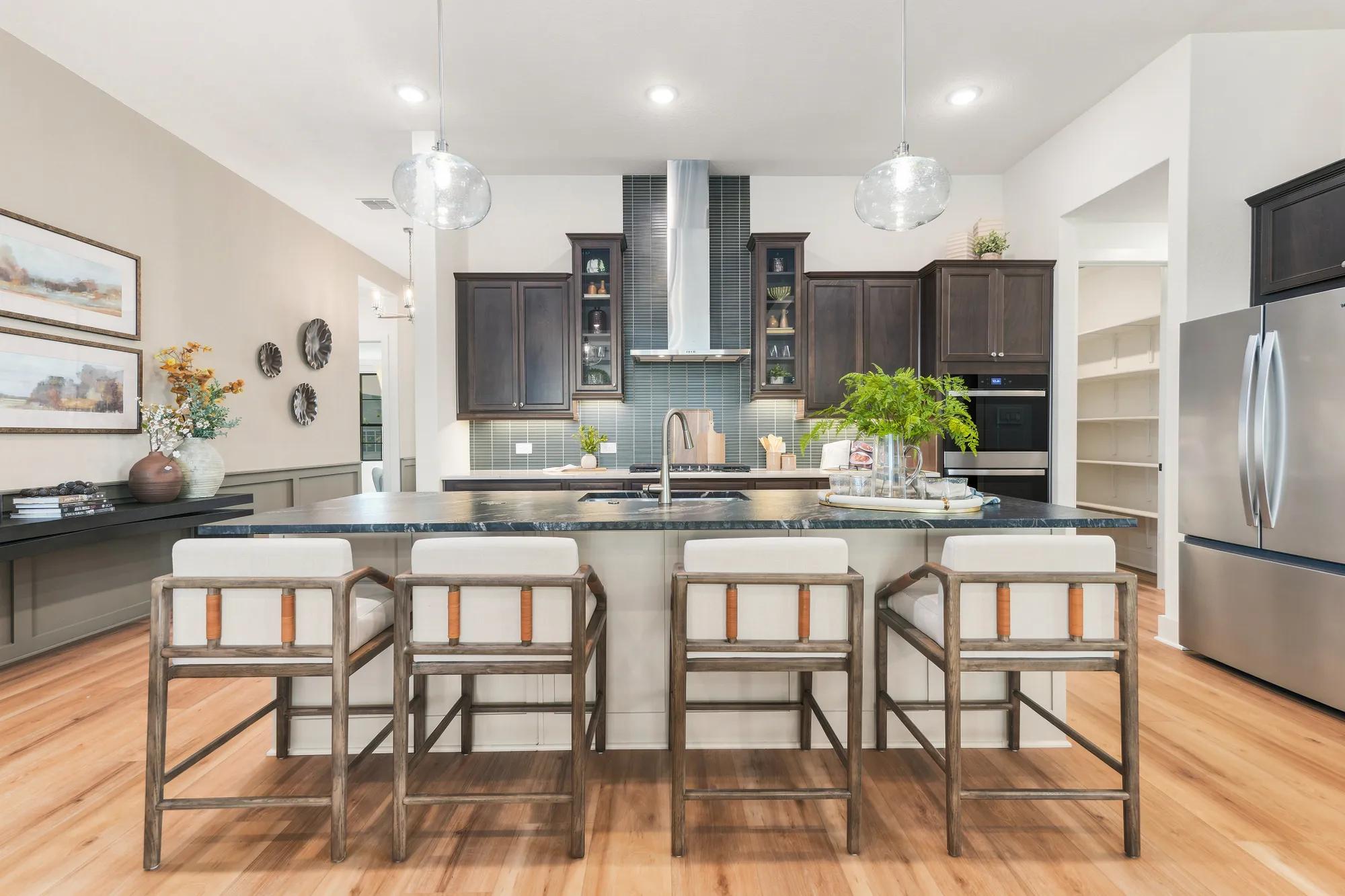 Custom Home Kitchen with dark wood cabinets and luxury vinyl tile floors