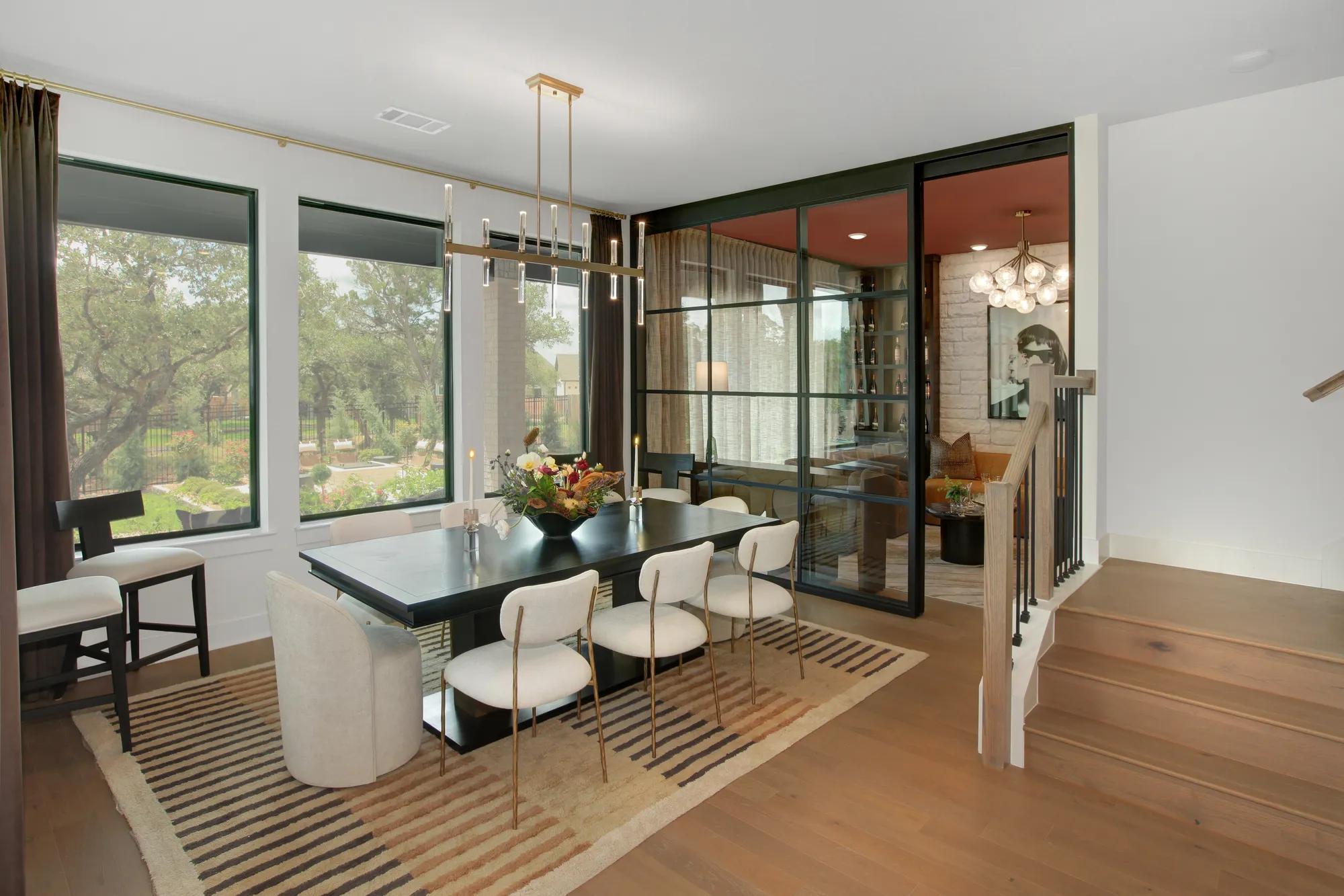 Modern home dining room with glass wall and door to flex room