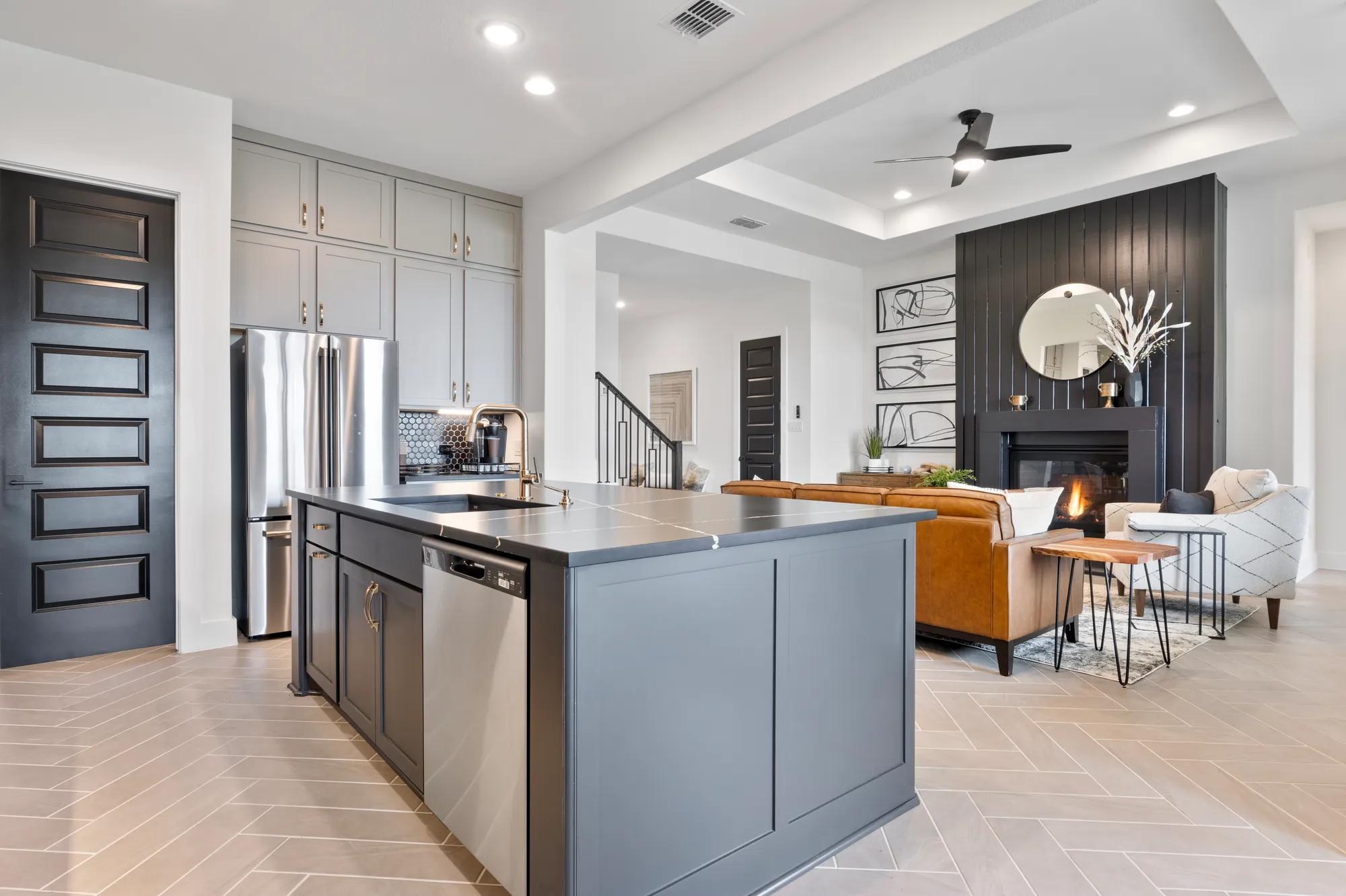 Custom home open floor plan kitchen and family room with tile floor