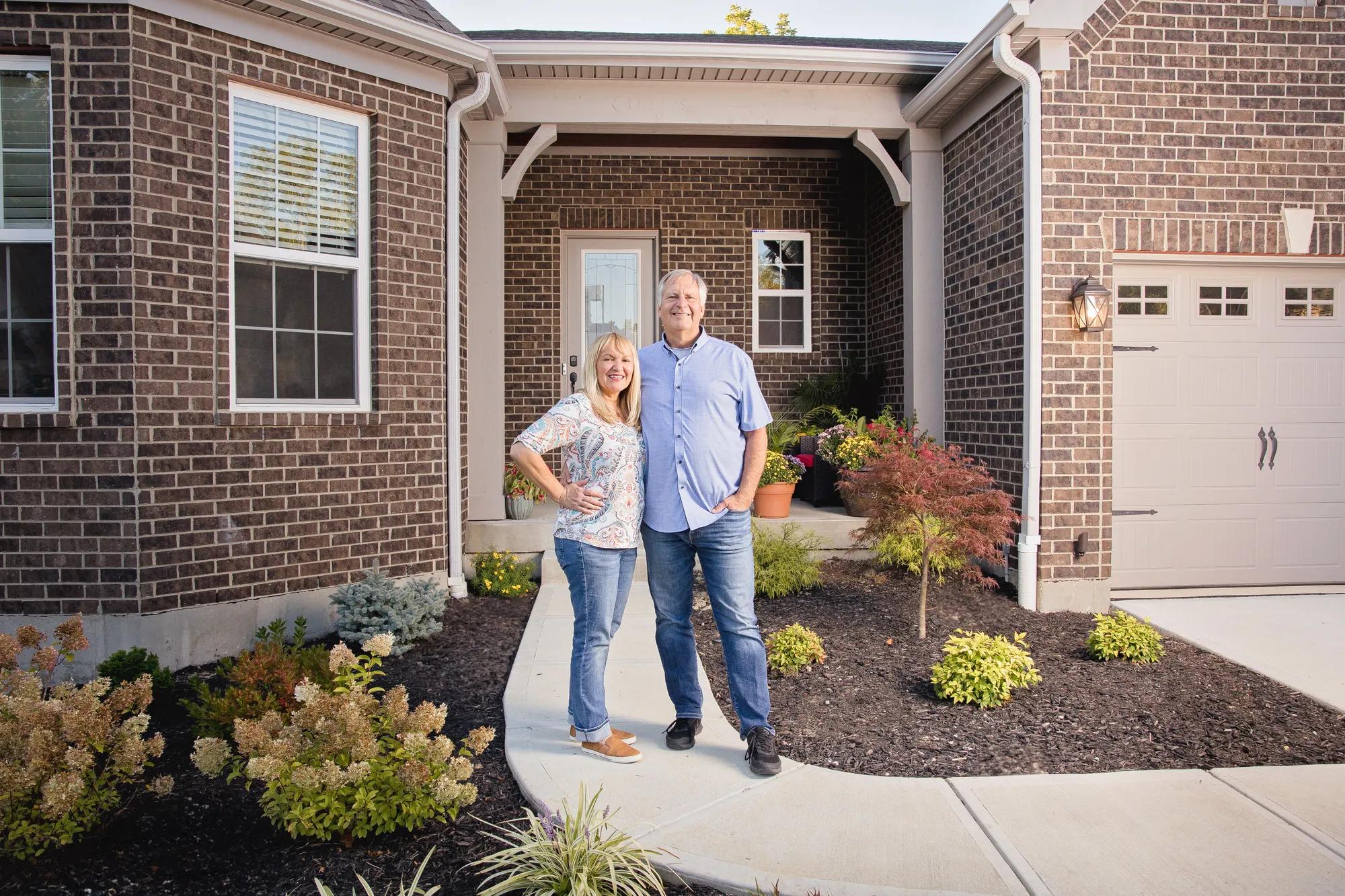 New homeowners outside of their Drees home
