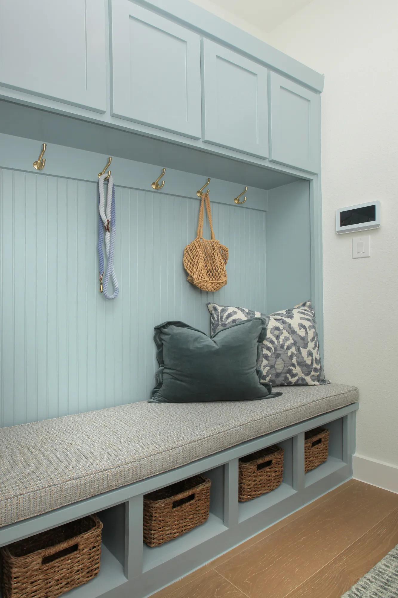 Custom home foyer storage with built in bench and painted cabinets
