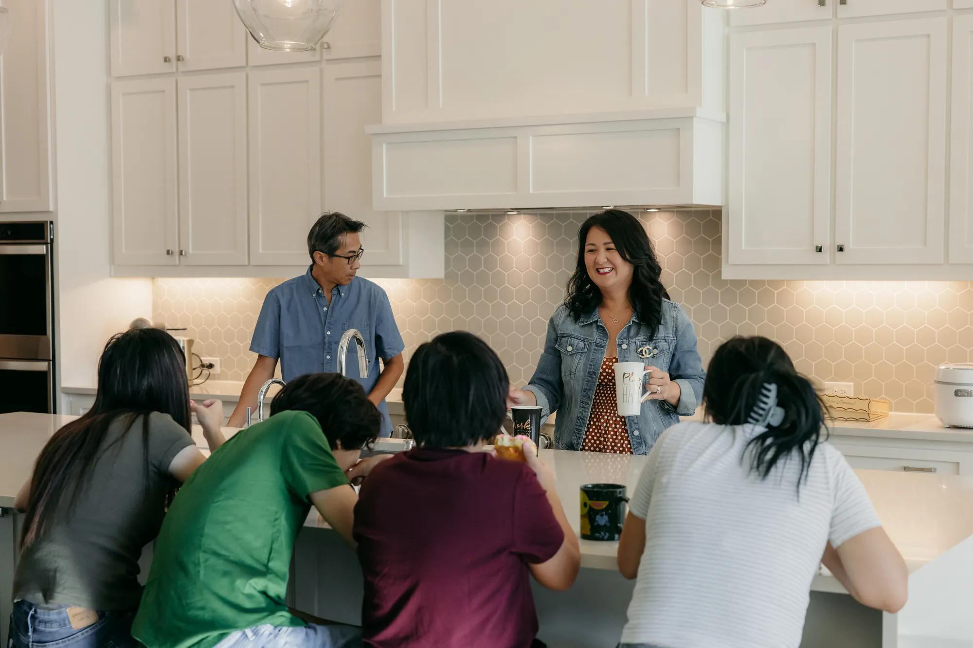 New homeowner family enjoying their beautiful kitchen with many modern touches