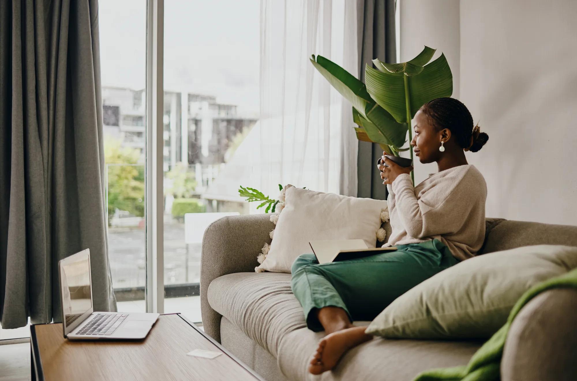 Woman relaxing on sofa in new home