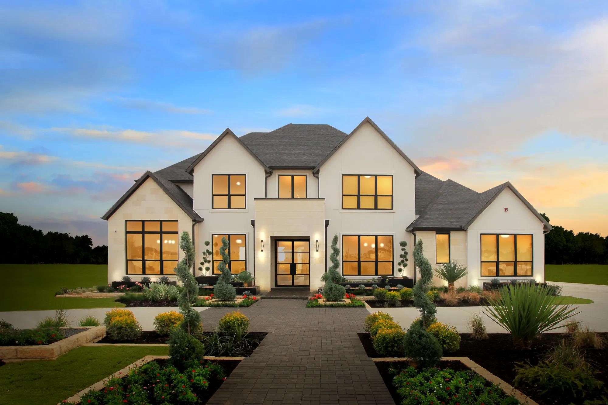 White exterior new construction home with landscaped front yard