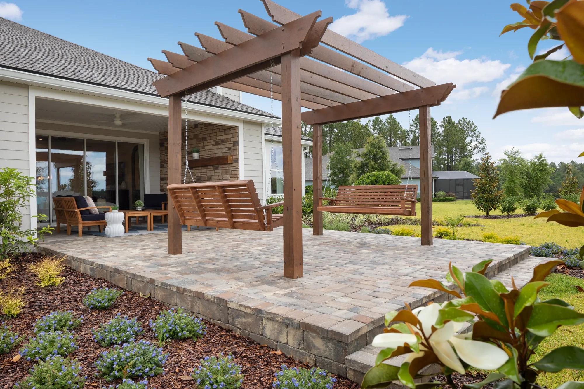 paver patio with pergola and swings