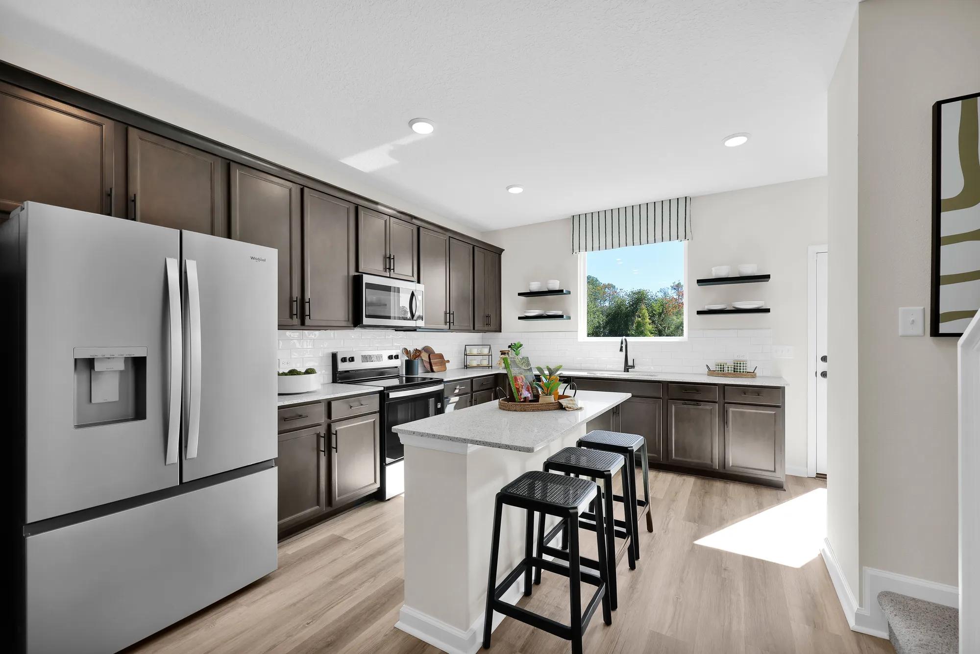 black matte finishes
vinyl flooring
stainless steel appliances
island