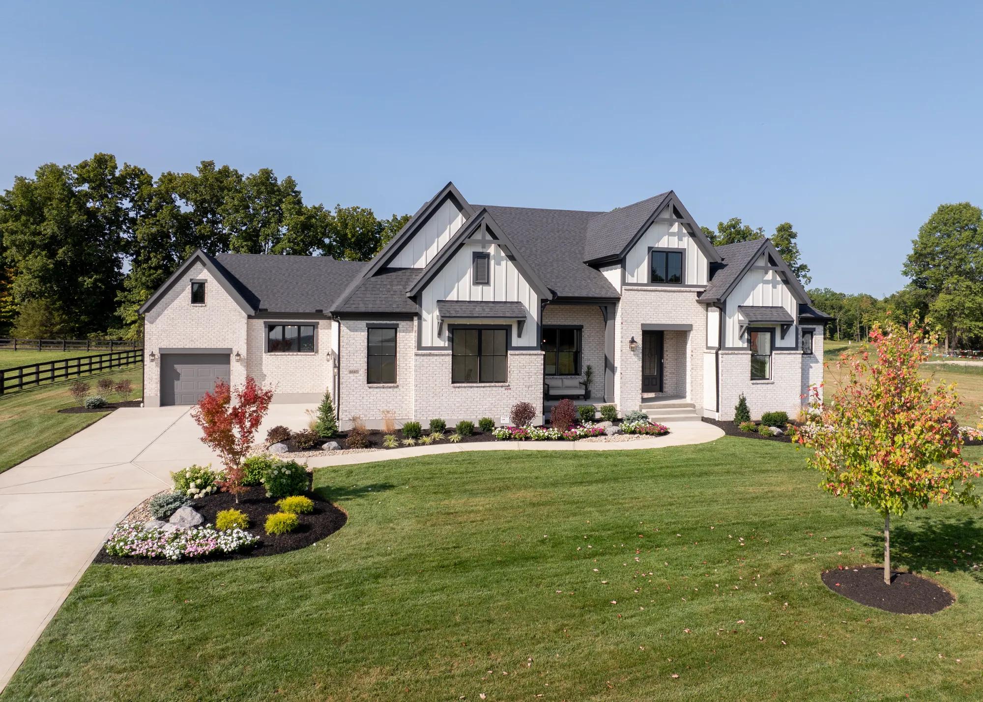 custom home with brick and board and batten exterior