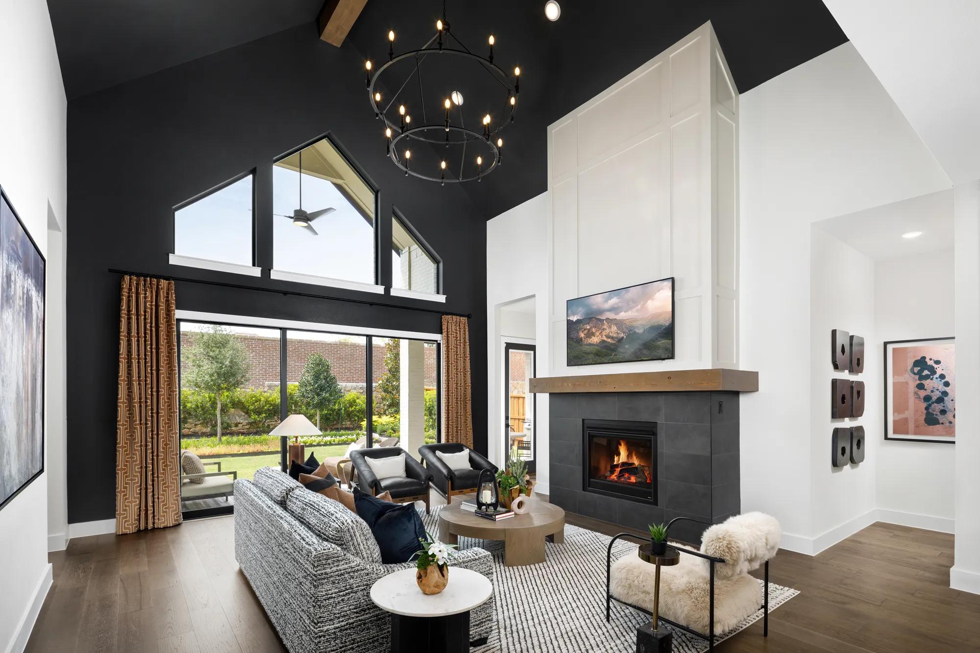 Custom home black and white family room with modern fireplace and vaulted painted ceiling
