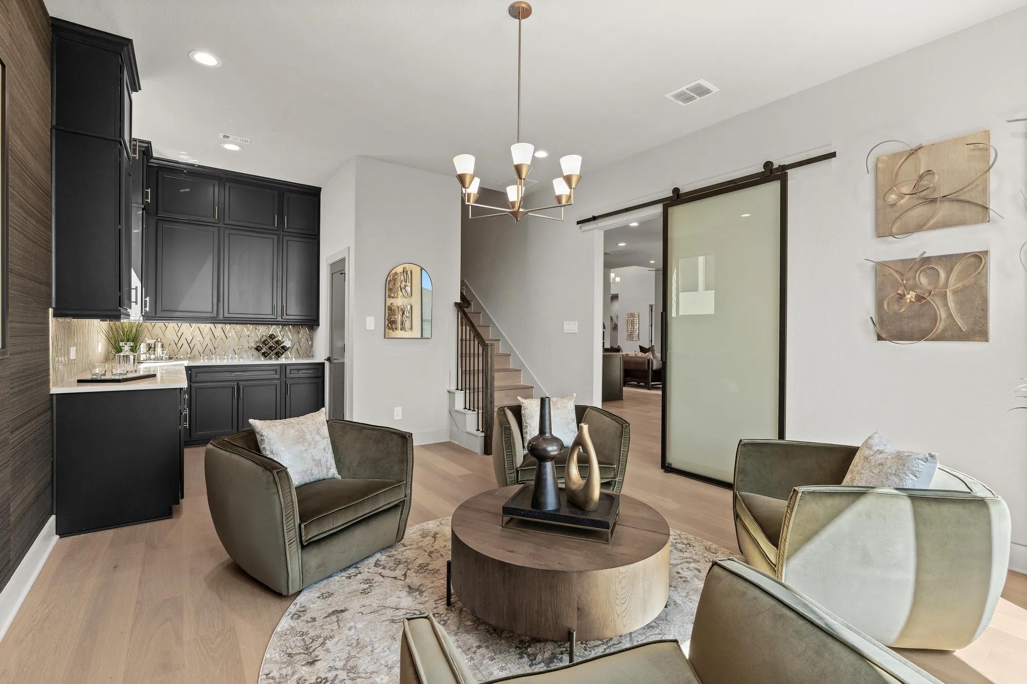 Custom home flex room with built in bar and sliding barn door