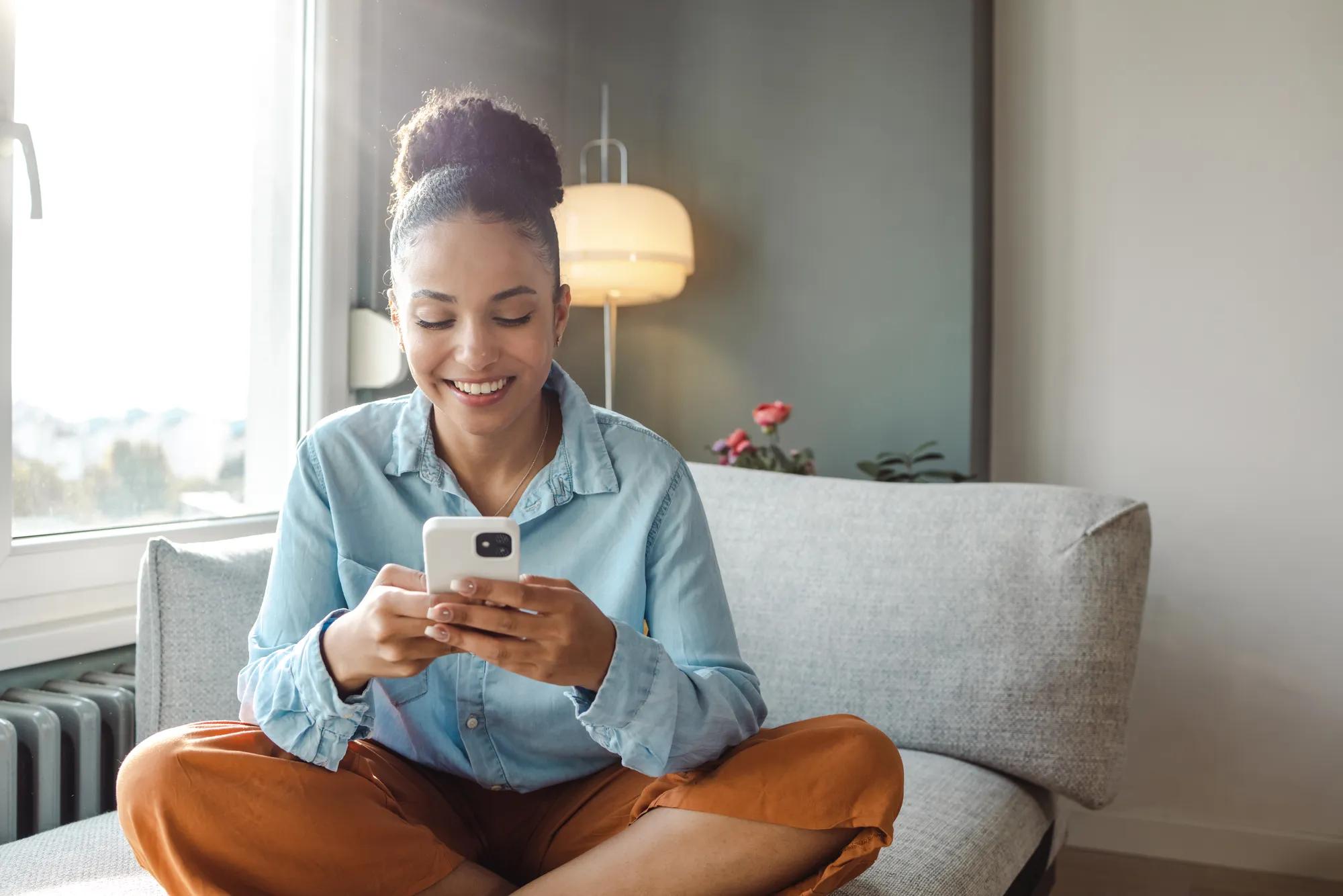 Woman using phone in family room