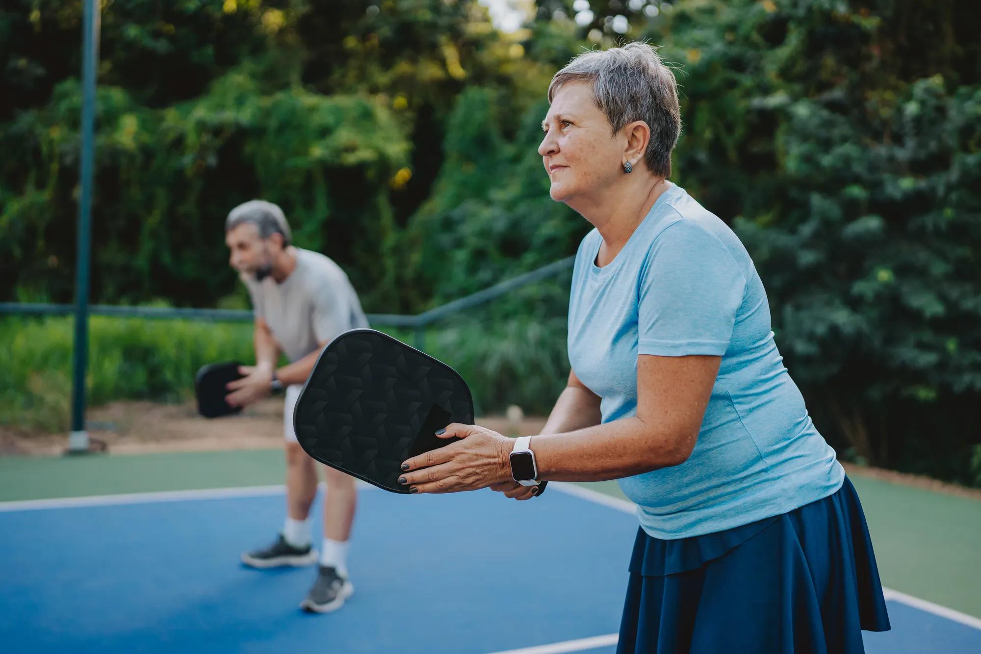 Couple playing on pickleball courts
