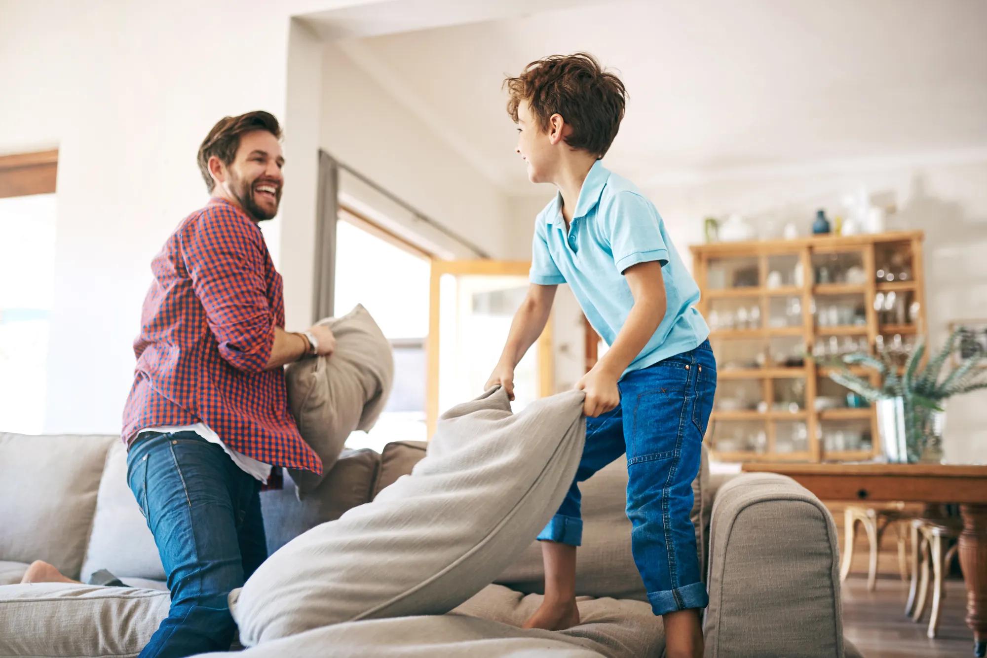 Father son playing in new home family room