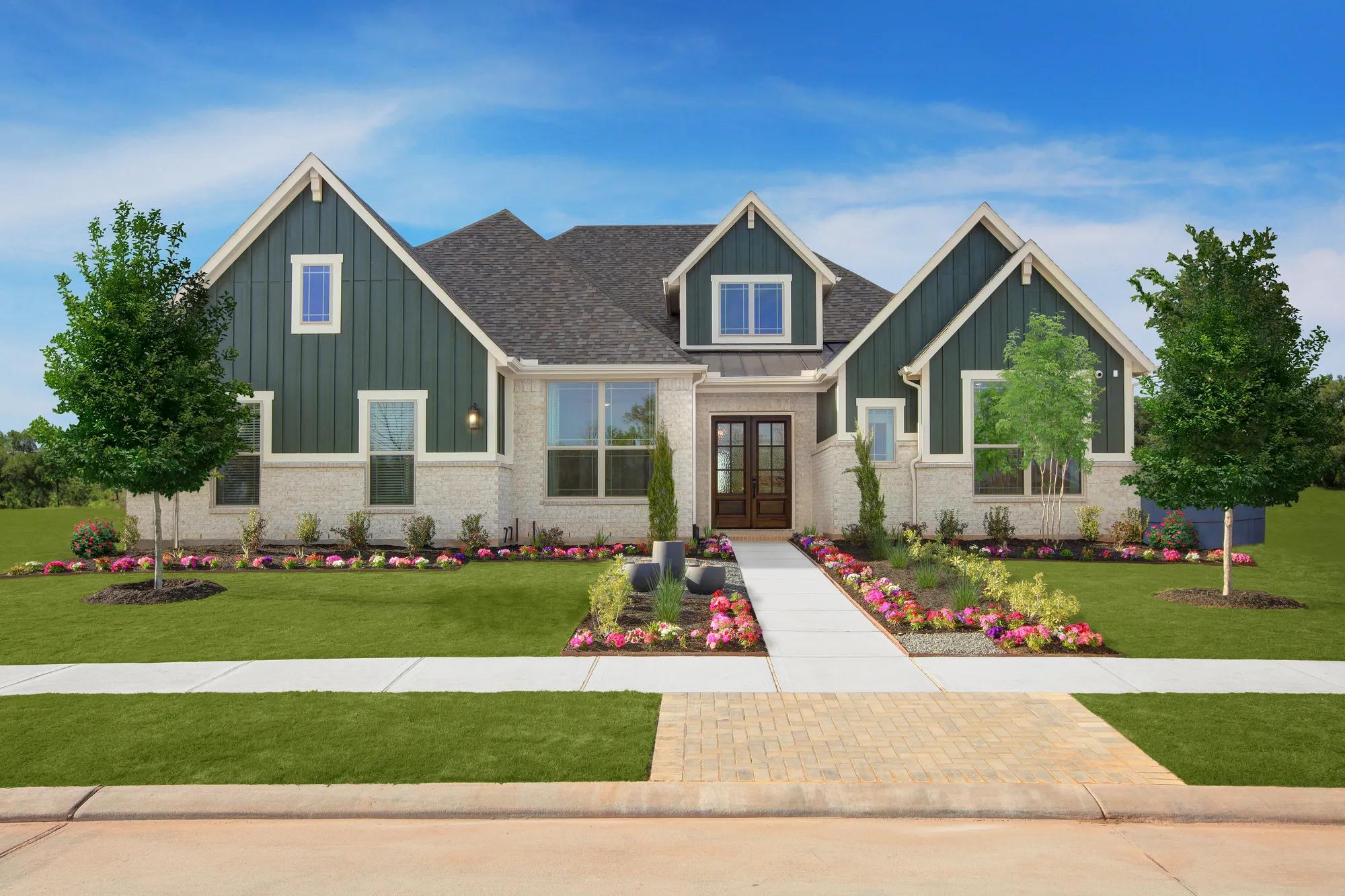 New home exterior with green vertical siding and light brick 