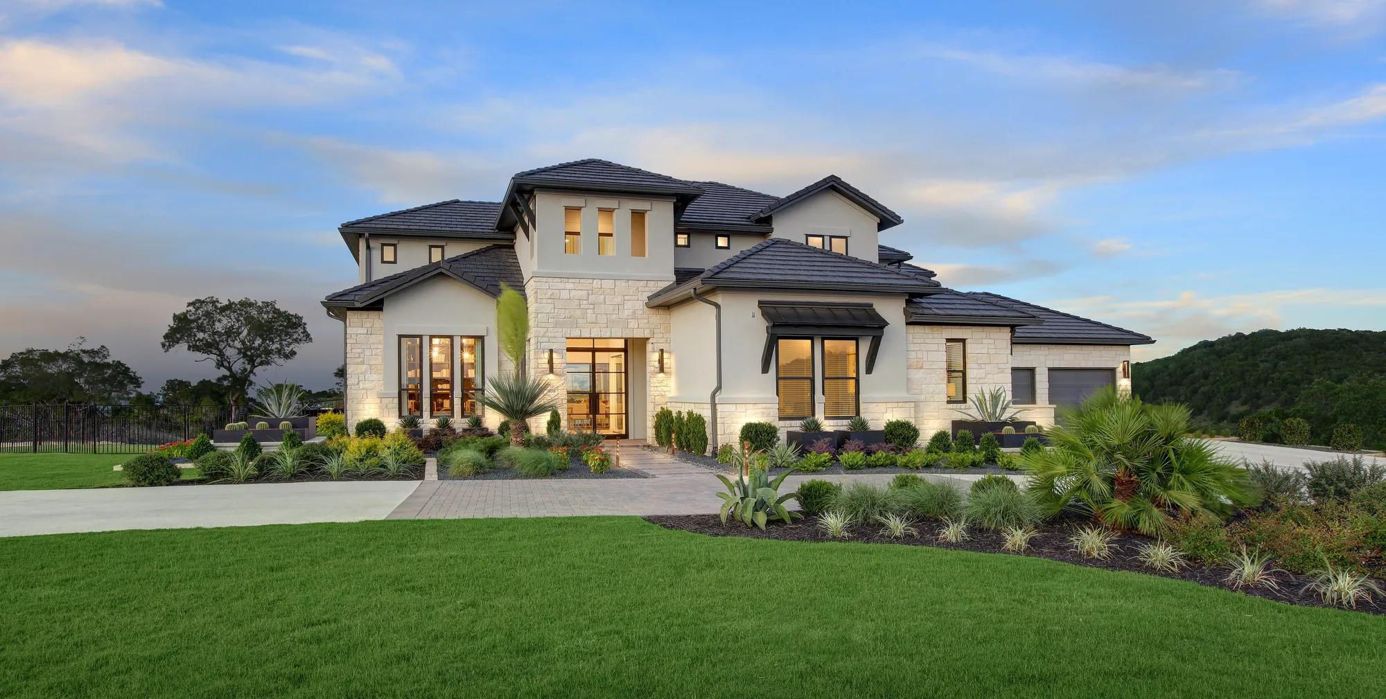 custom two-story home with stone and stucco exterior