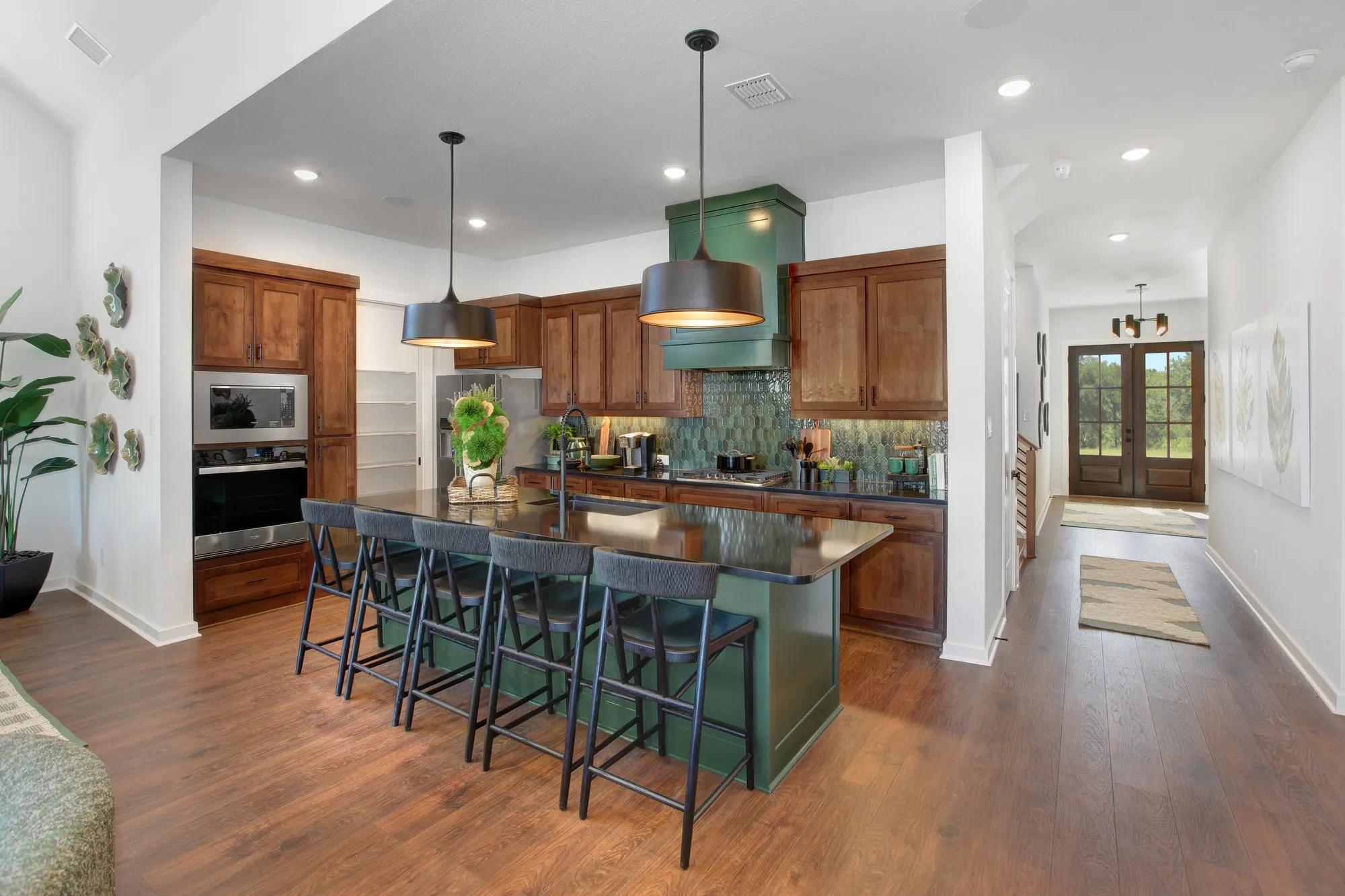 custom home kitchen with green island