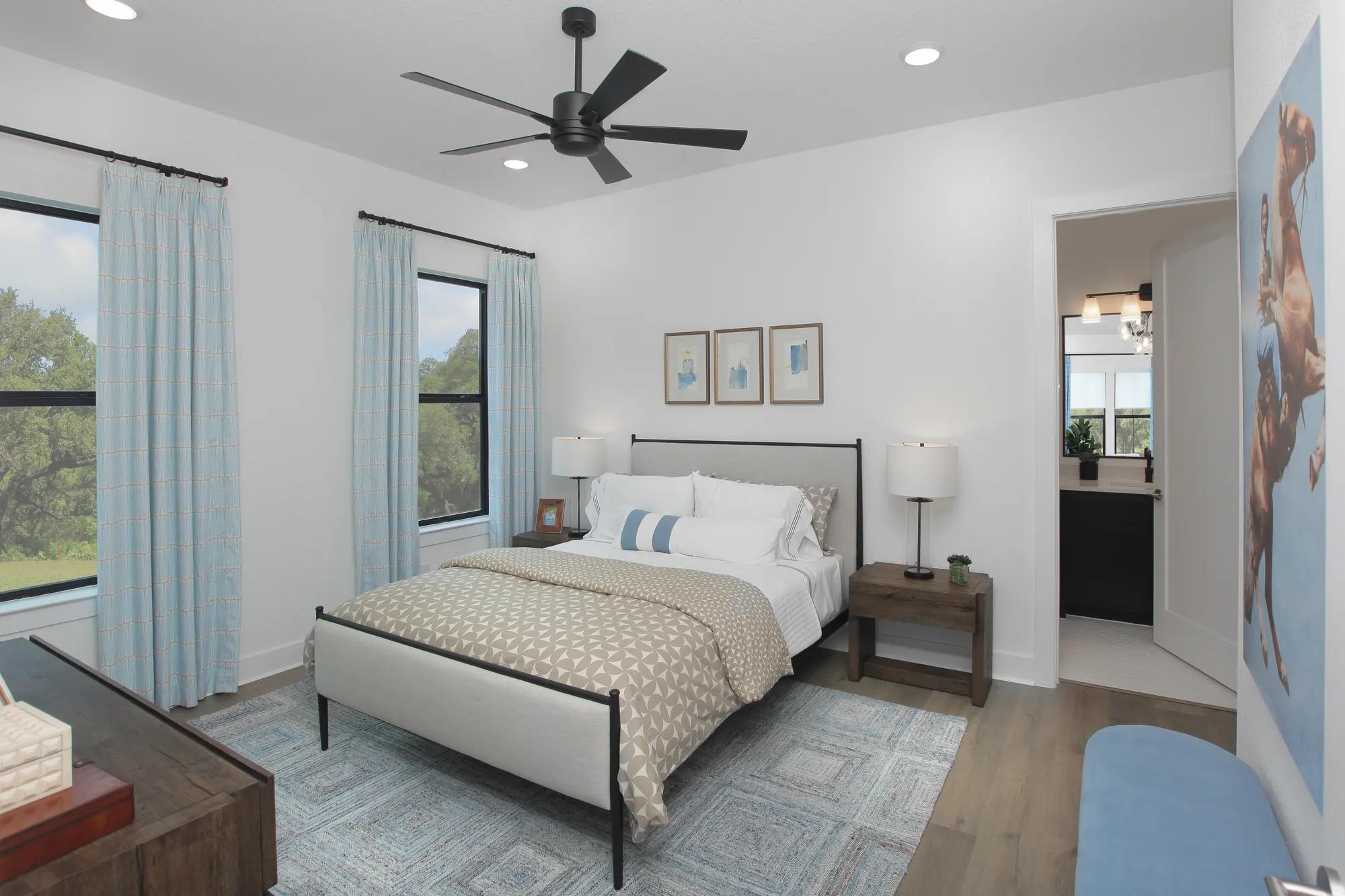 New home bedroom with hardwood floor and ensuite bathroom