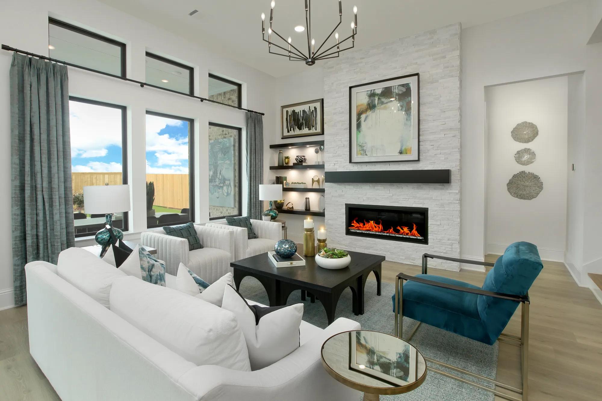 Custom home family room with stone fireplace and wall of windows