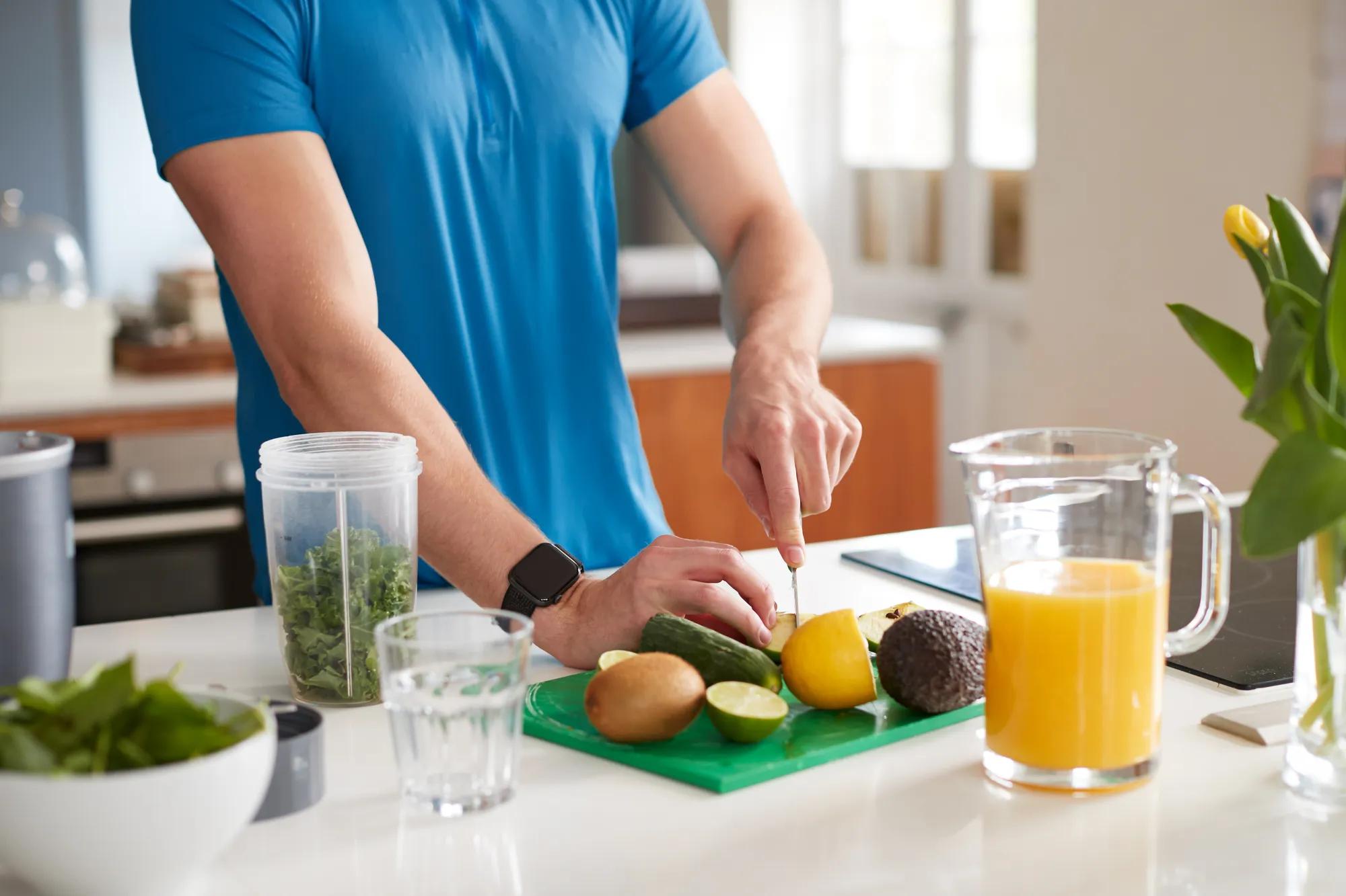 Man chopping fruit in new home kitchen