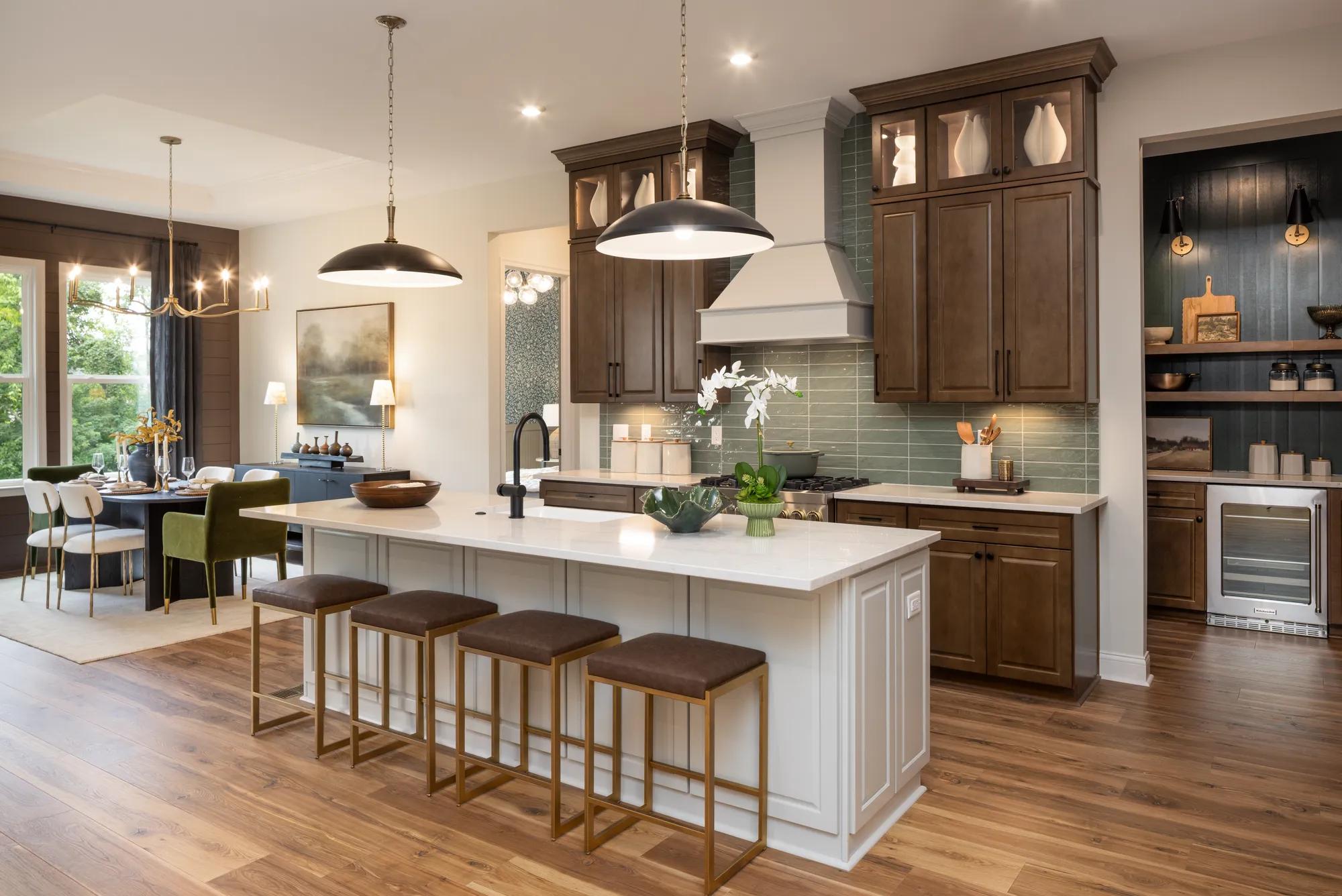 Custom home kitchen with working pantry, island, and open concept dining room