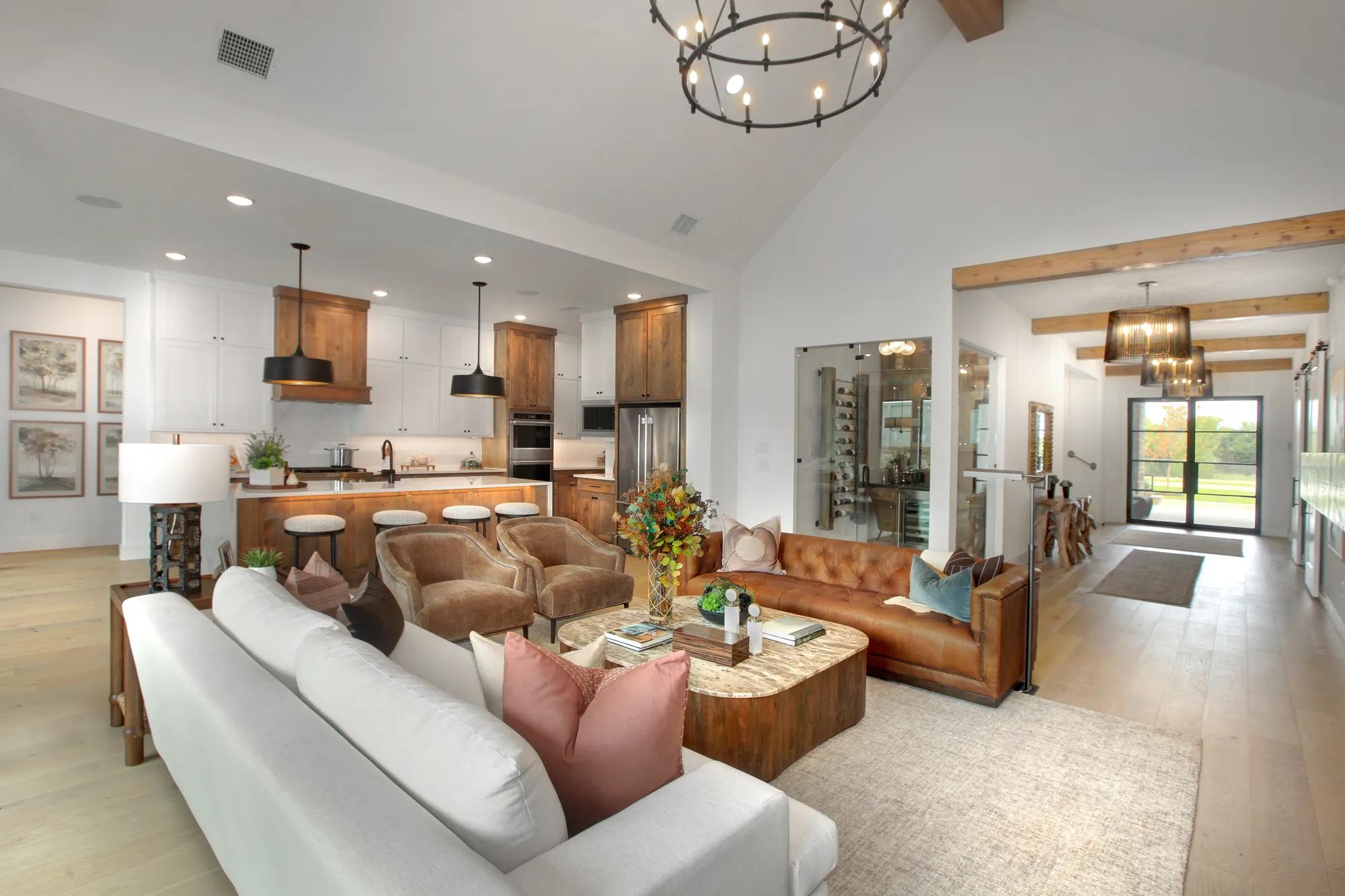 New home open floor plan family room with kitchen, wine room, and foyer